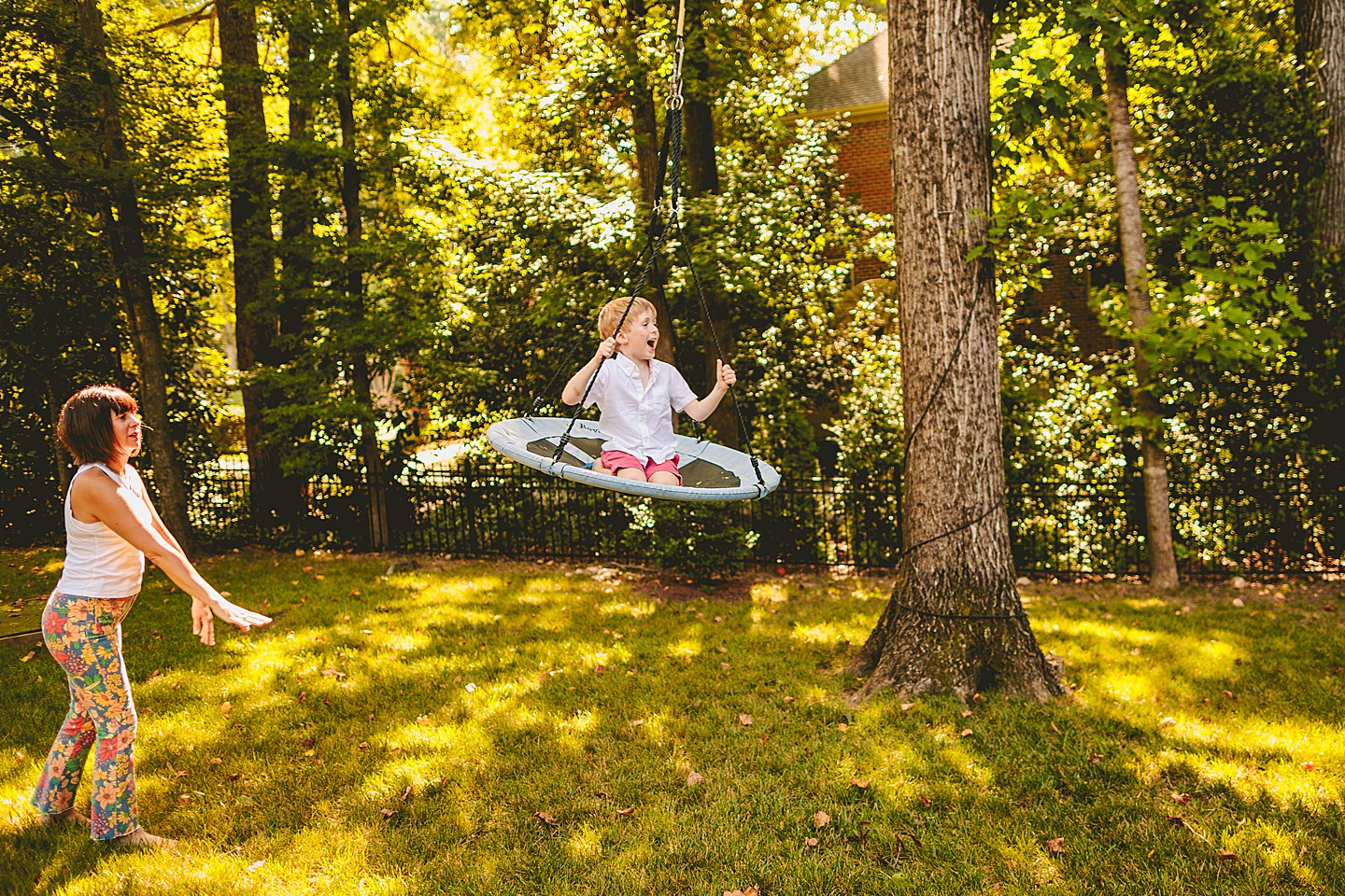 Kid swinging in backyard