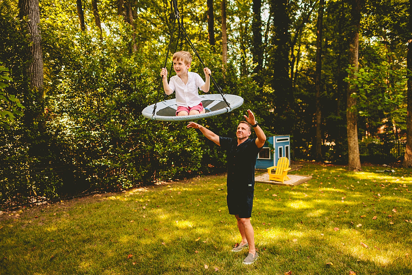 Kid swinging in backyard