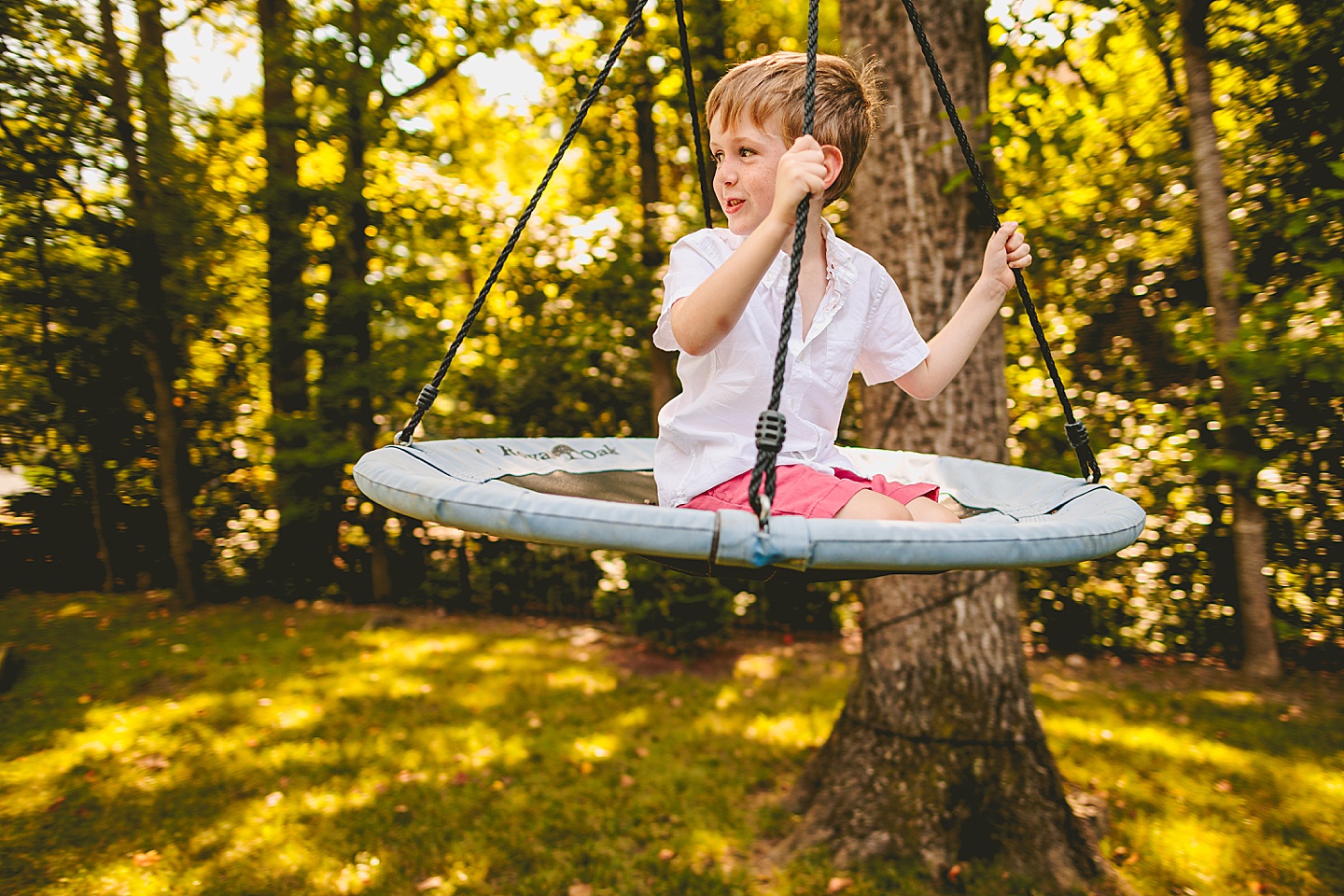 Kid swinging in backyard