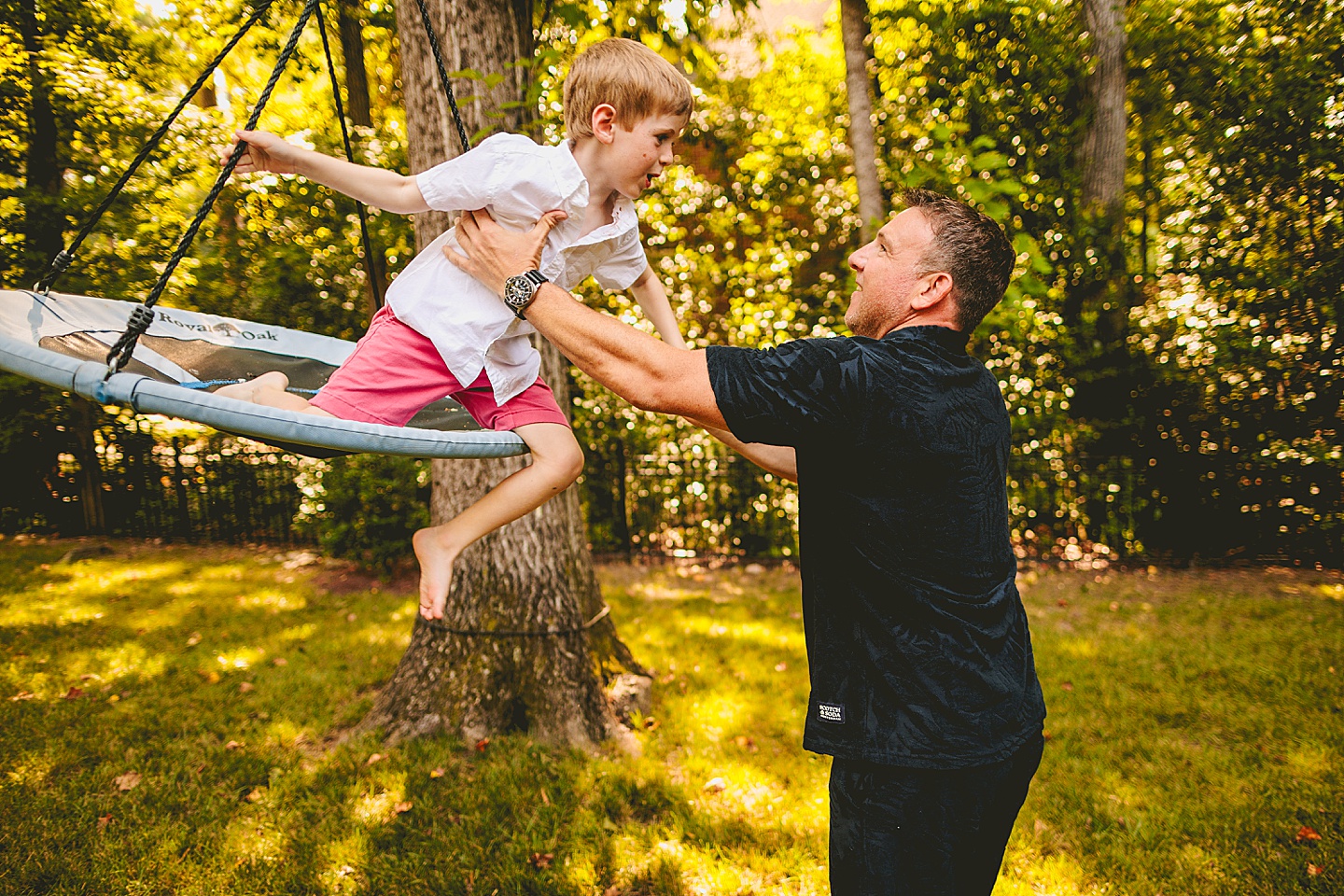 Kid swinging in backyard