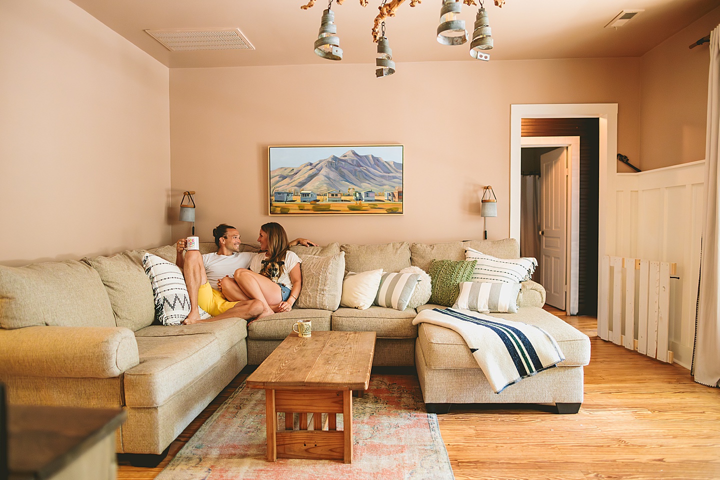 Couple sitting on their couch holding their small dog