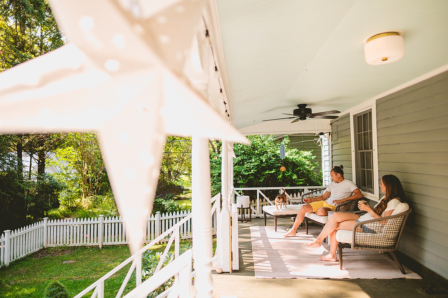 Couple sitting on porch outside in the south