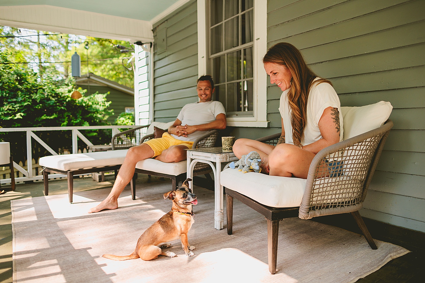 Couple sitting on porch outside in the south