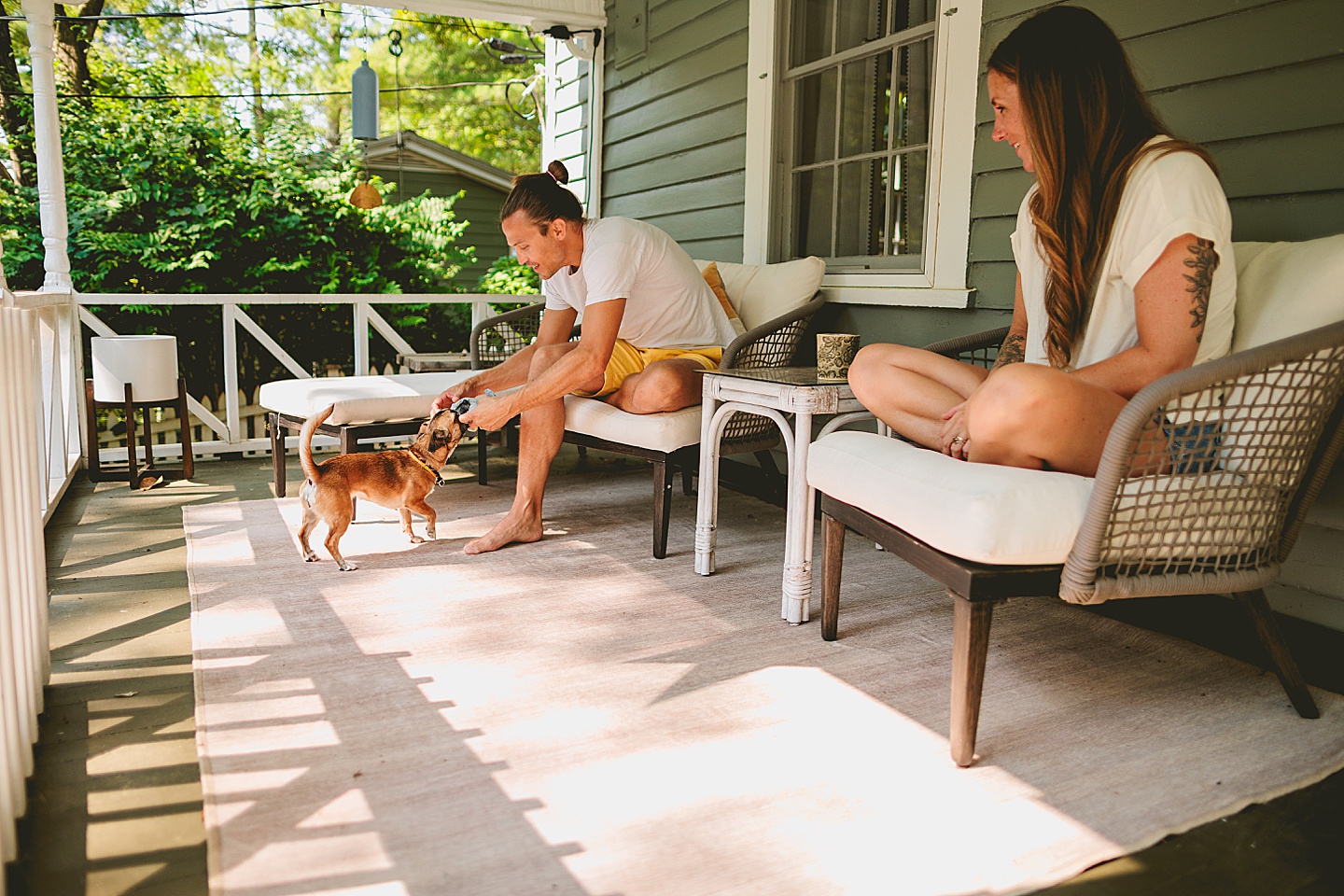 Couple sitting on porch outside in the south