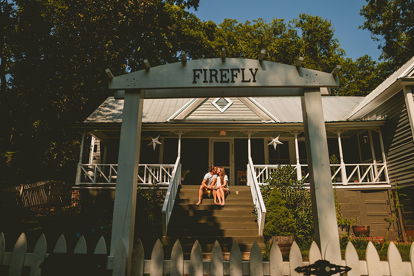 Couple sitting on porch outside in the south