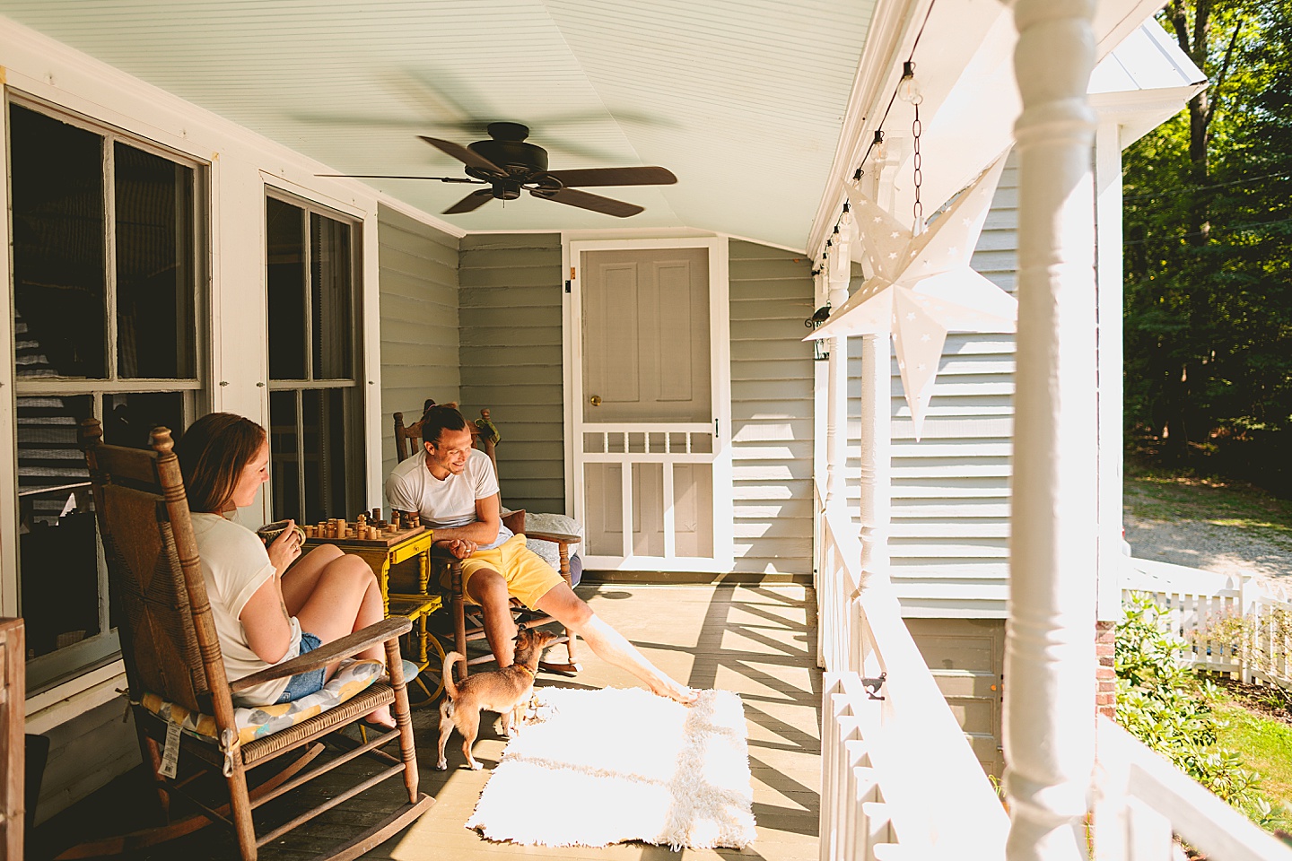 Couple playing chess on porch