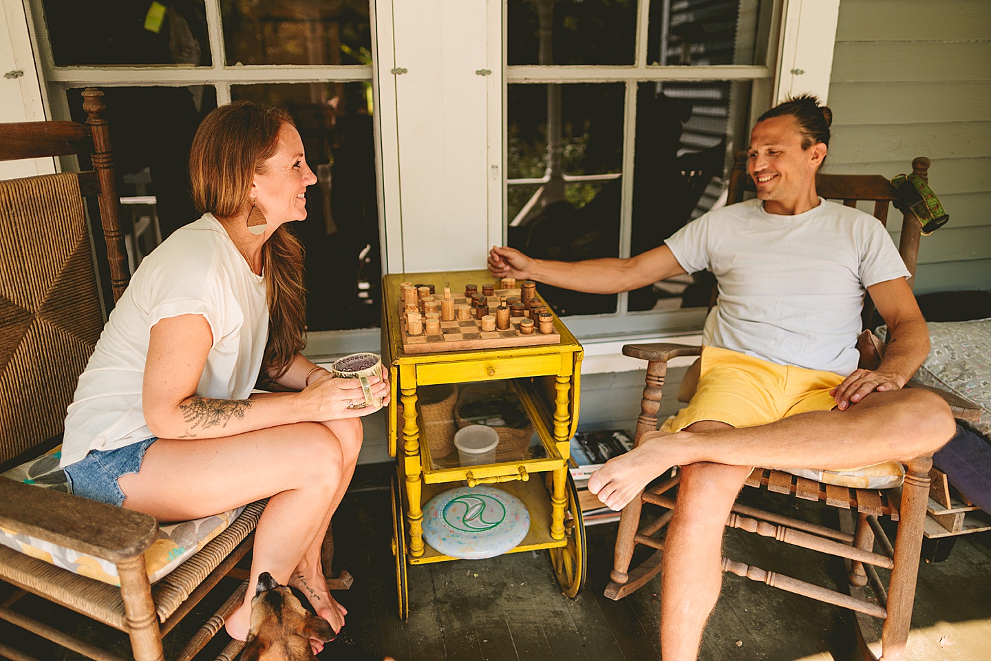 Couple playing chess on porch