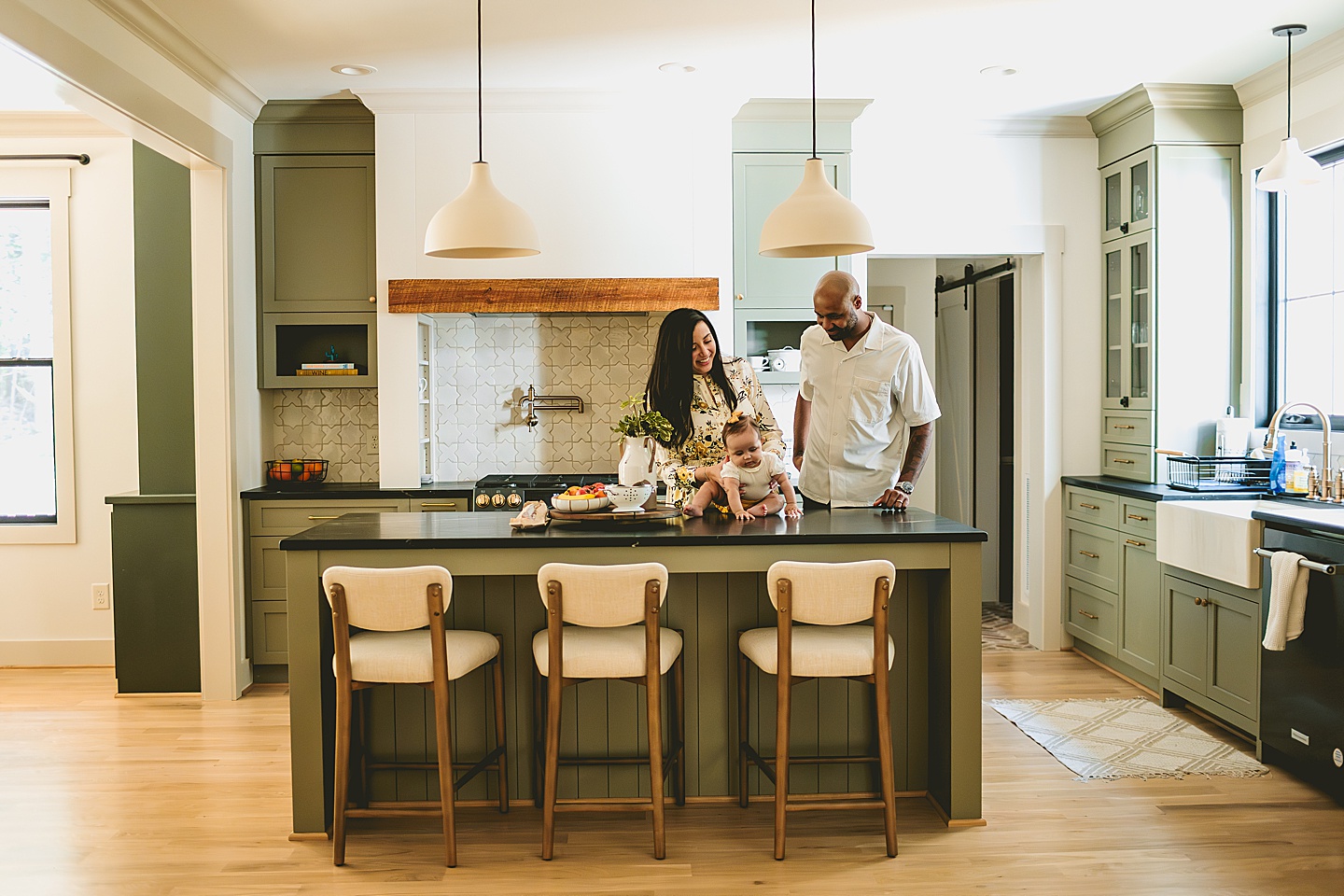 Family with baby hanging out in kitchen