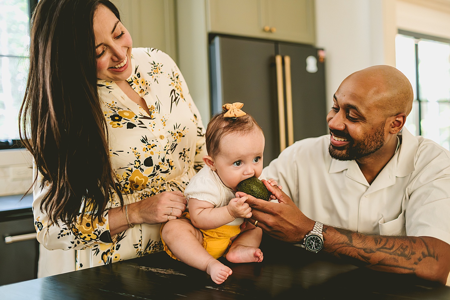 Family with baby hanging out in kitchen