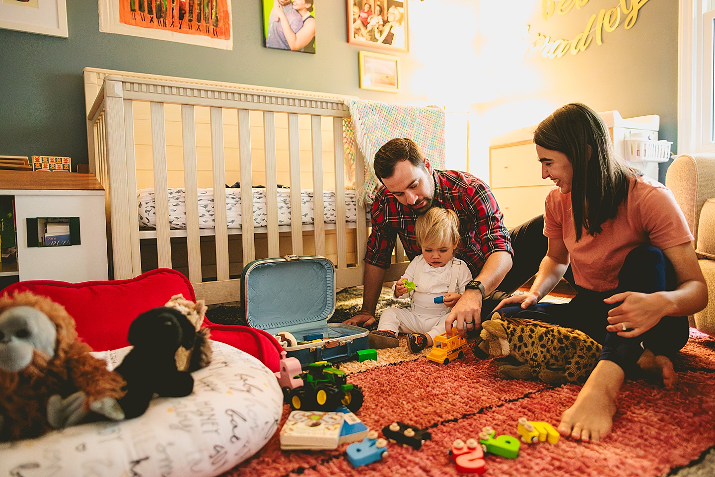 Baby playing with toys on the floor of his nursery