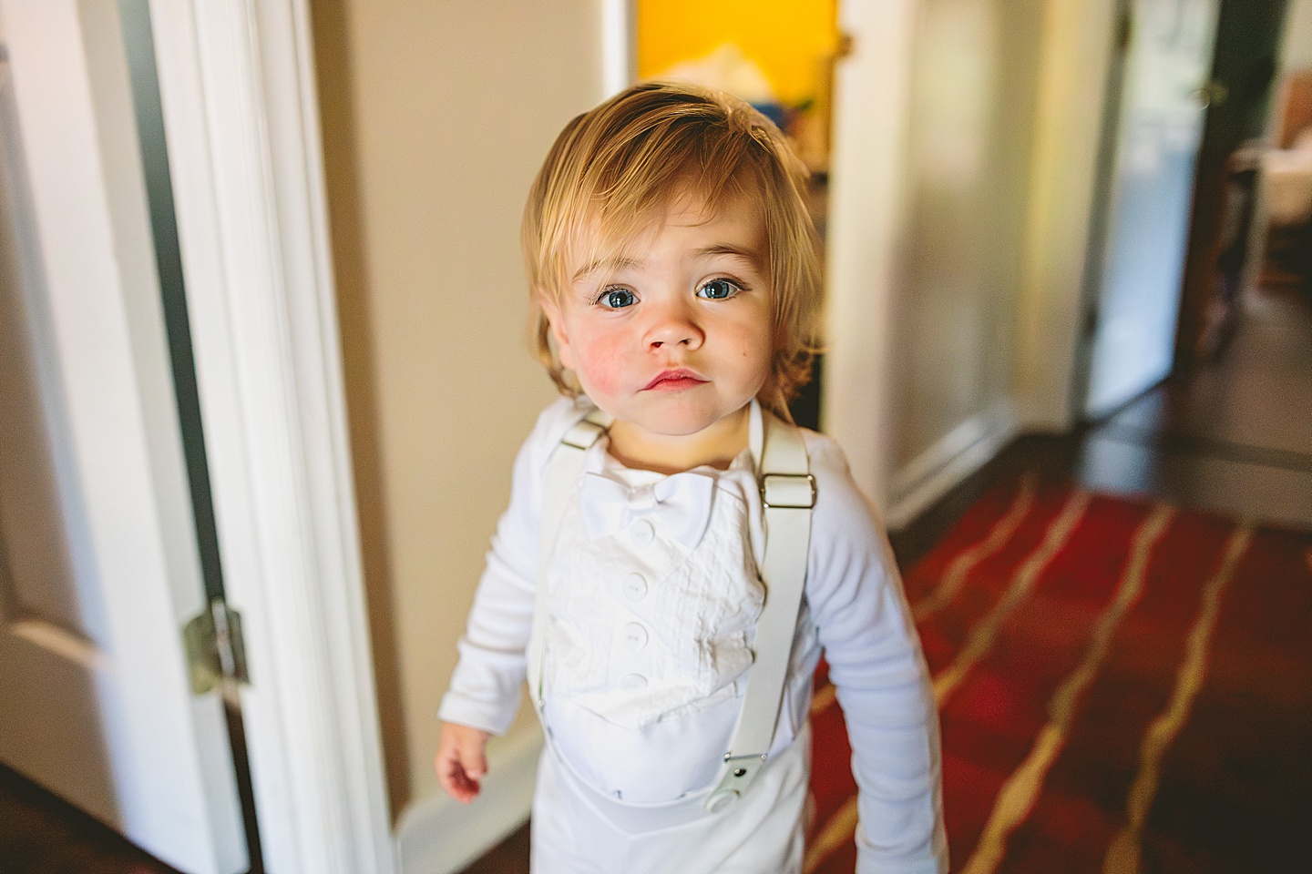 Baby in white tuxedo