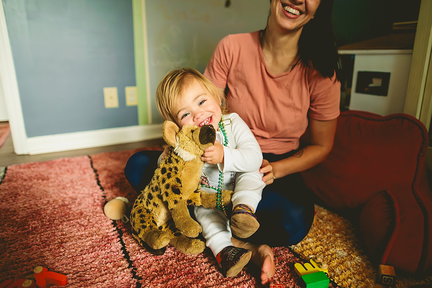 Toddler hugging stuffed animals