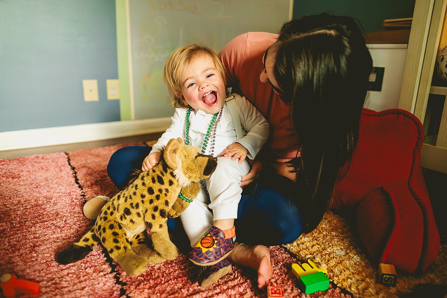 Toddler hugging stuffed animals