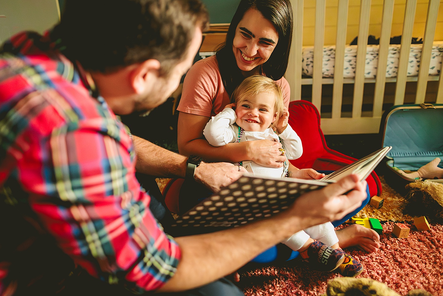 Family reading books to baby