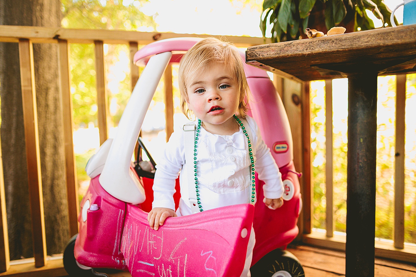 Toddler driving a toy car