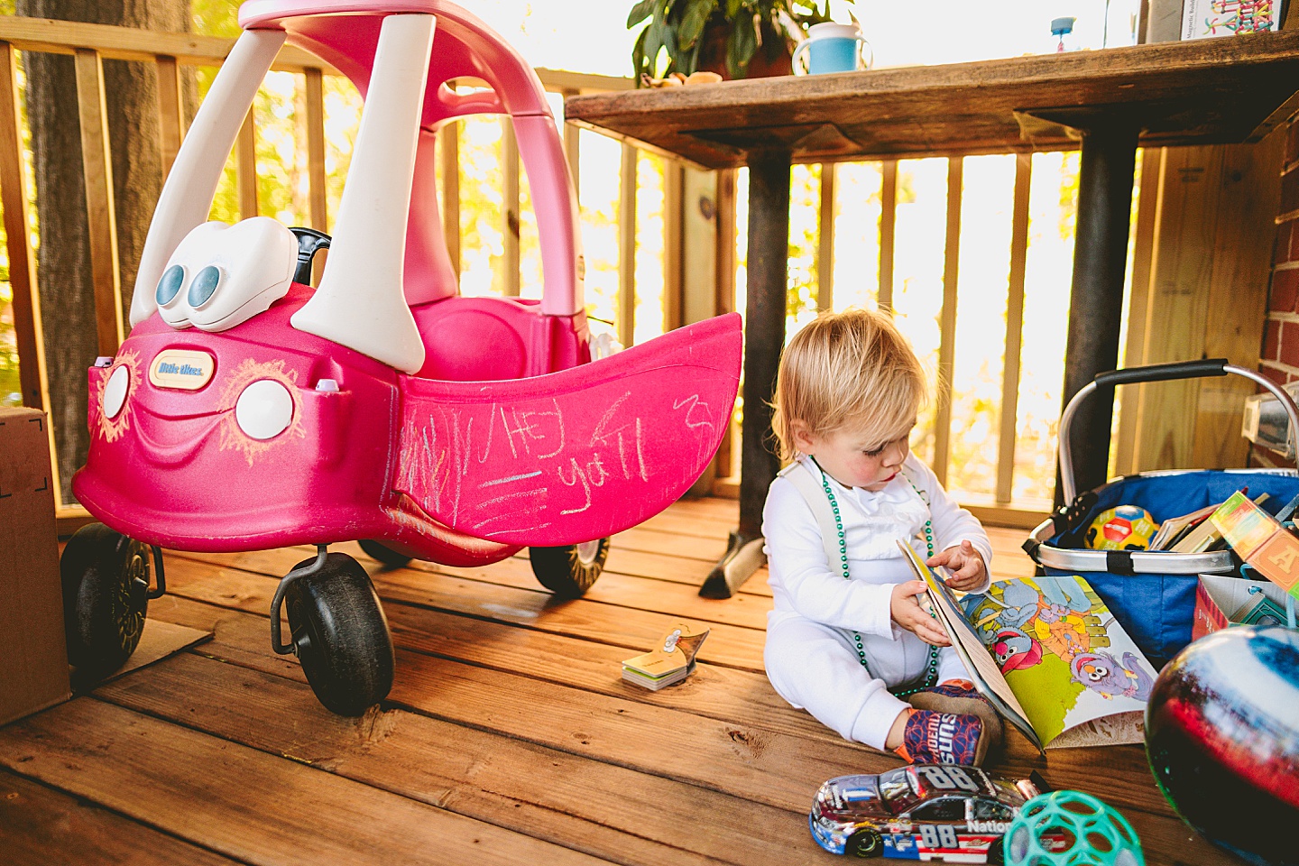 Toddler driving a toy car