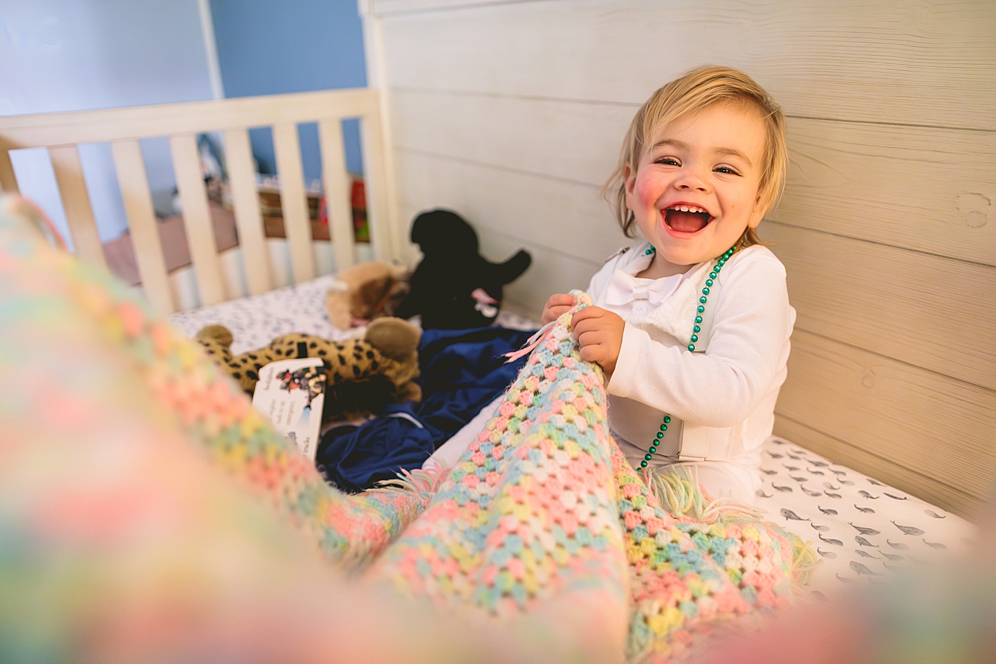 Toddler playing in crib
