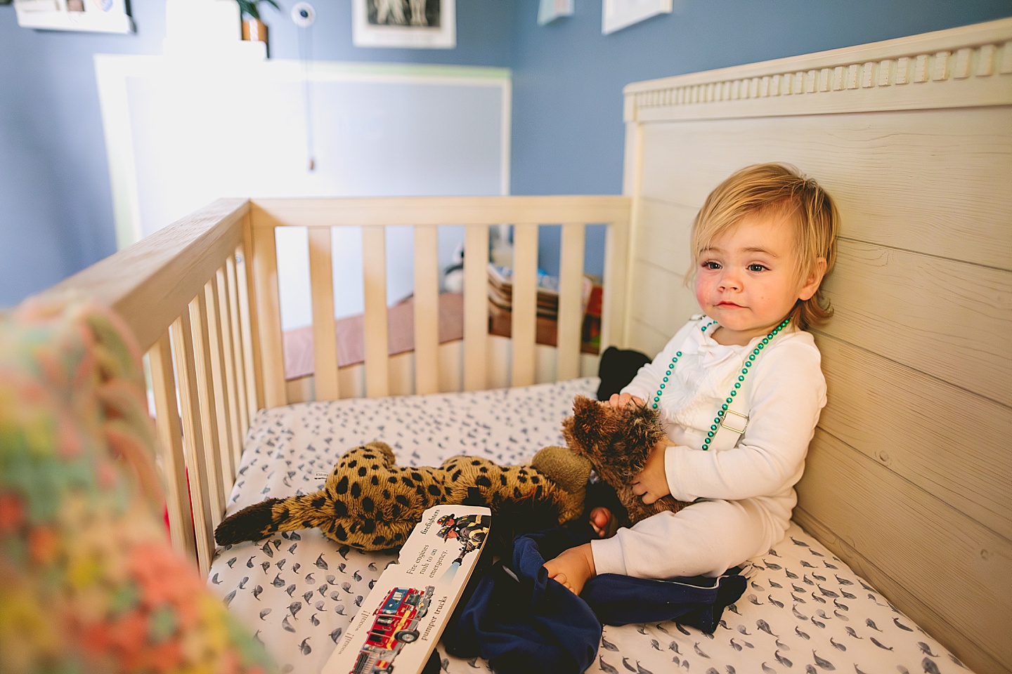 Toddler playing in crib