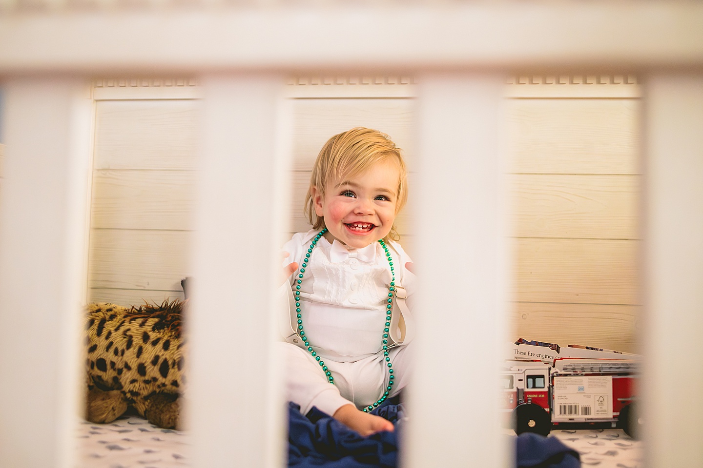 Toddler playing in crib