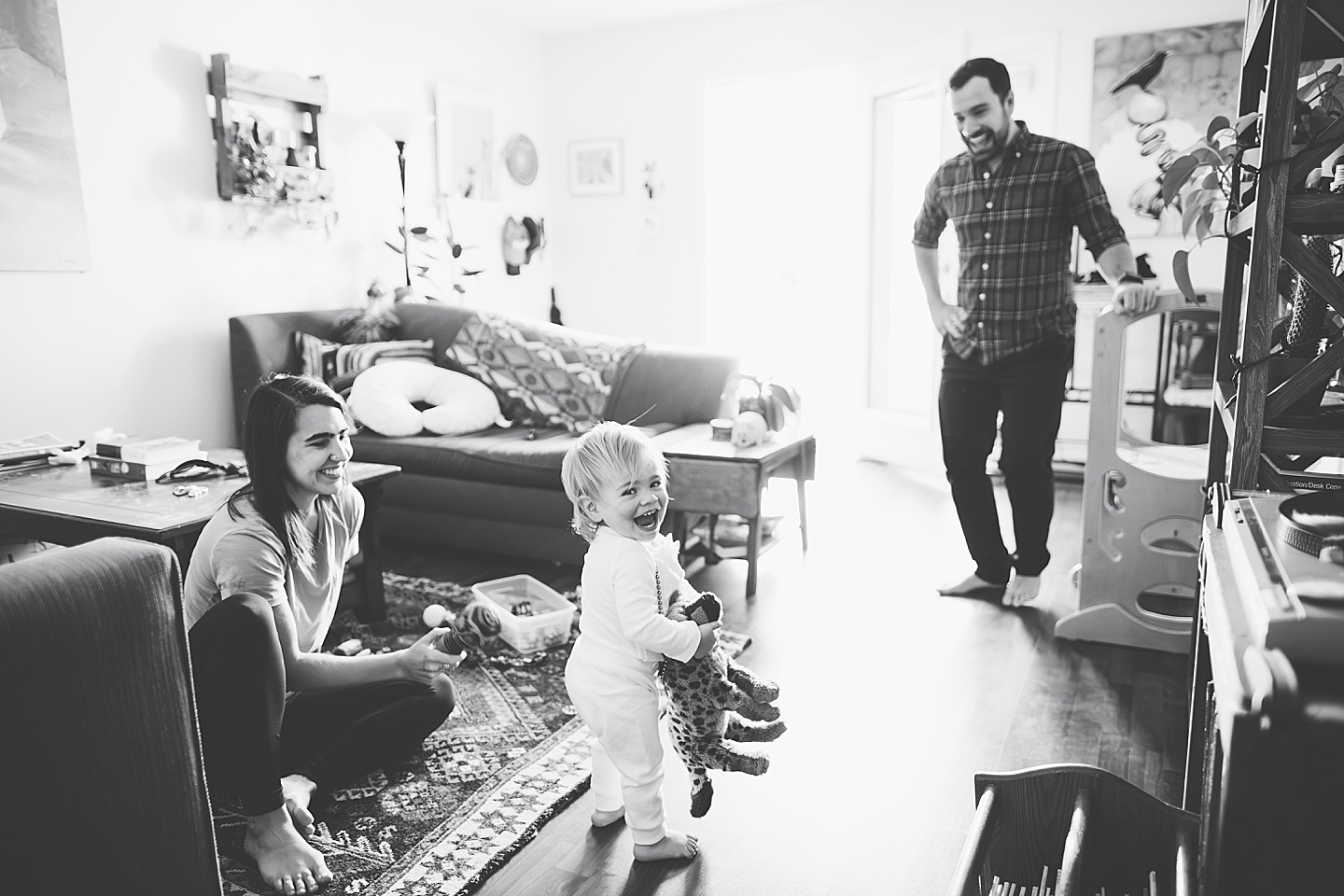 Toddler dancing and smiling in living room family photos