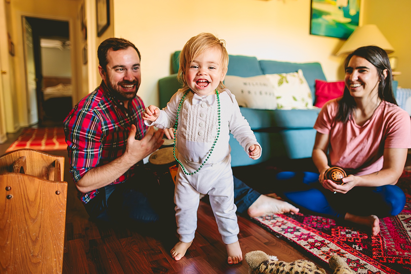 Toddler dancing and smiling in living room family photos