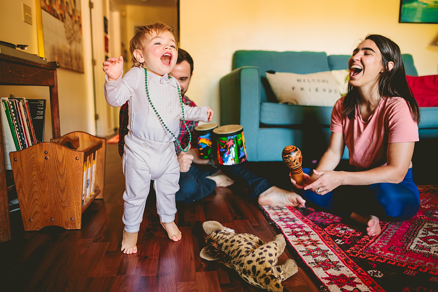 Toddler dancing and smiling in living room family photos