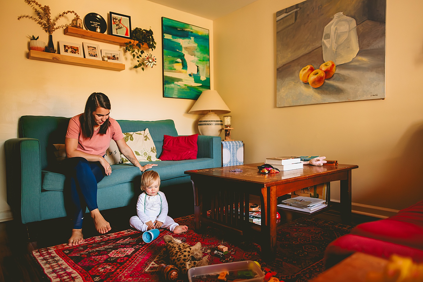 Toddler sitting in living room with mom