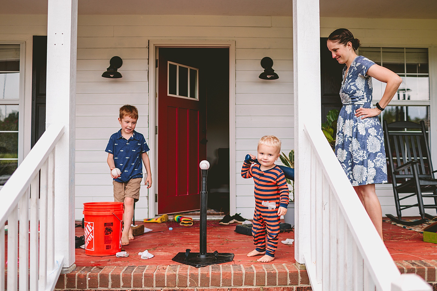 Kids playing baseball on porch