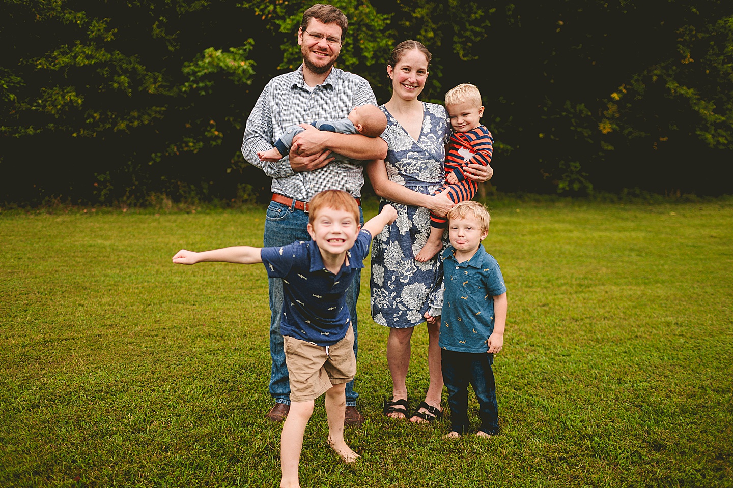 Family photo with kids making funny faces