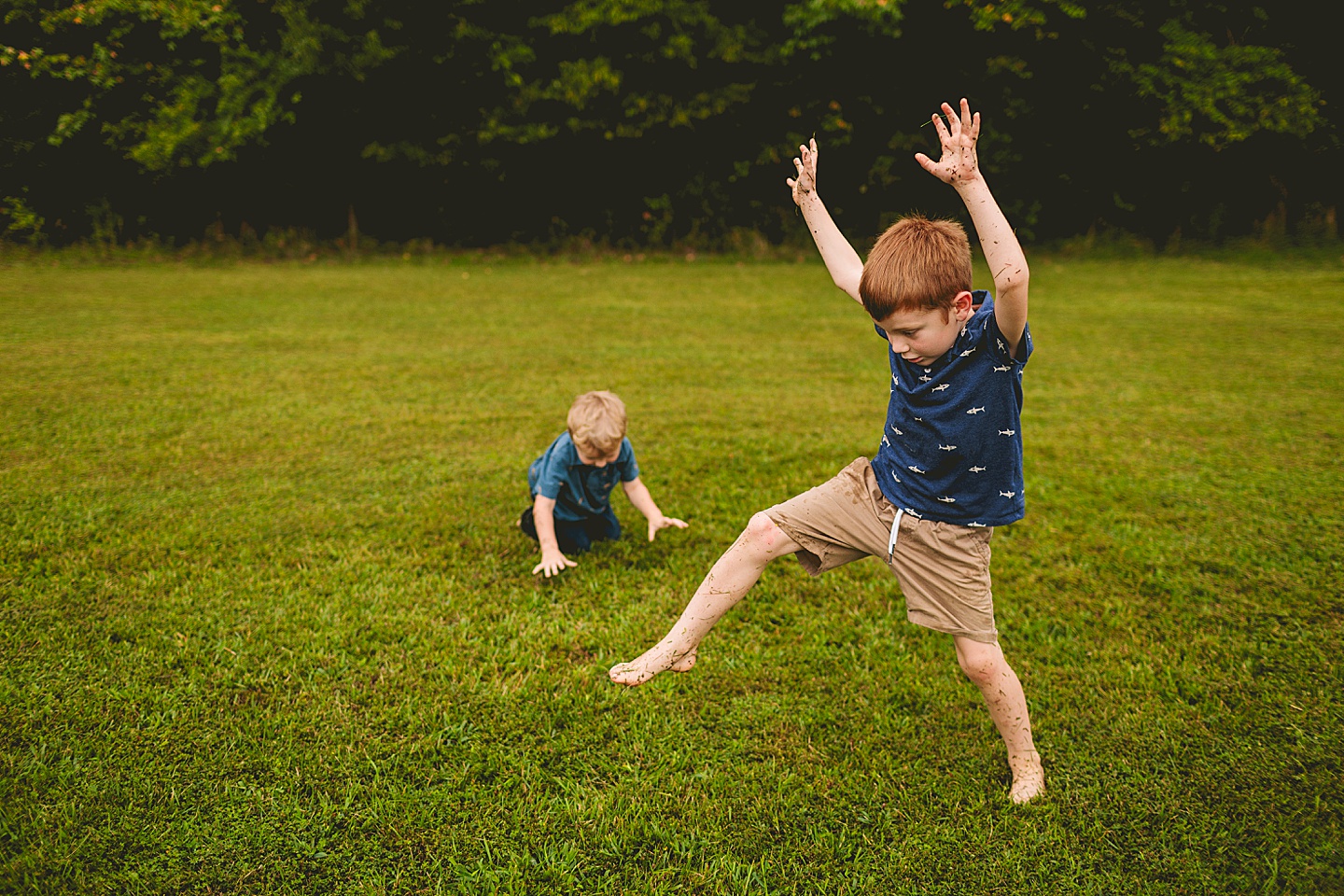 Kid doing cartwheel on lawn