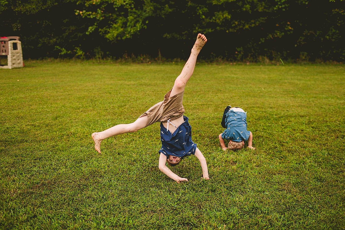 Kid doing cartwheel on lawn