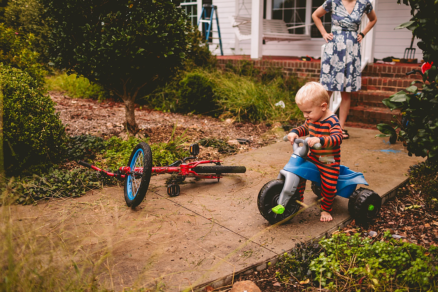 Kid riding big wheel