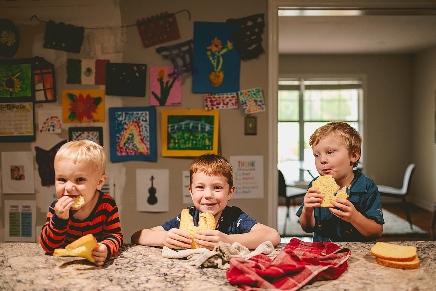 Three brothers eating bread