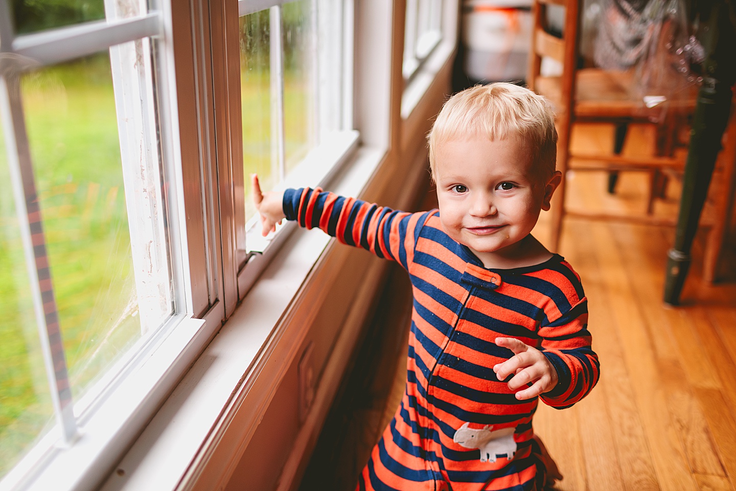 Kid sitting by the window