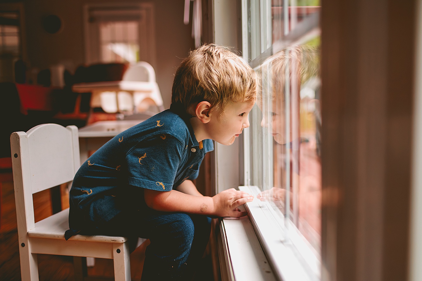 Kid sitting by the window