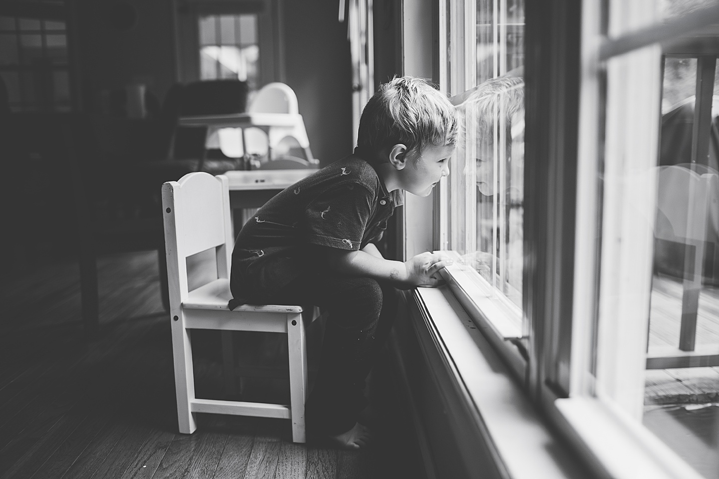 Kid sitting by the window