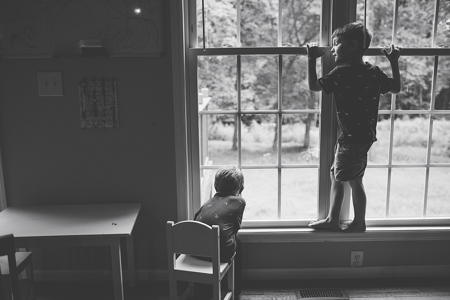 Kid sitting by the window