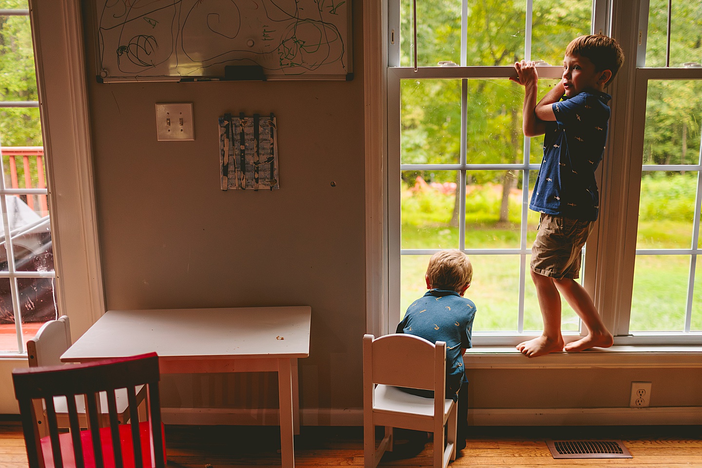 Kid sitting by the window