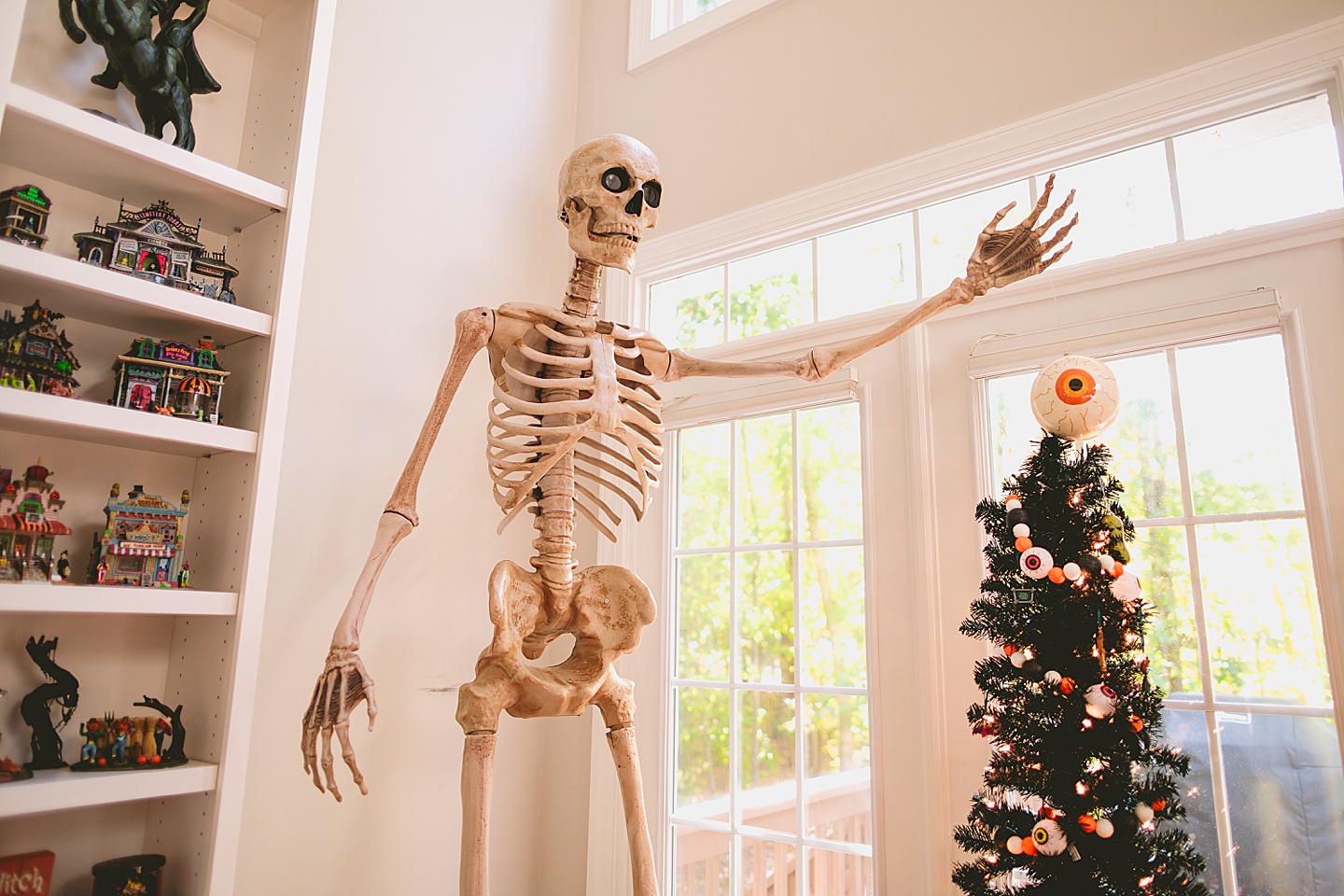 8' skeleton hanging an eyeball on a Halloween tree