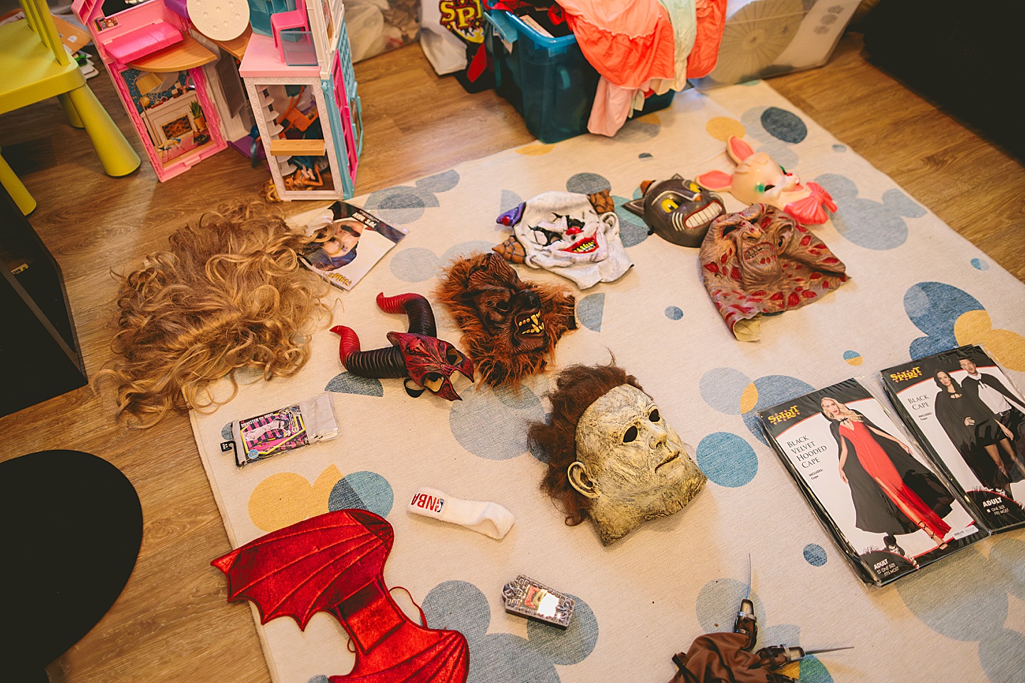 A variety of Halloween costumes laying on the floor