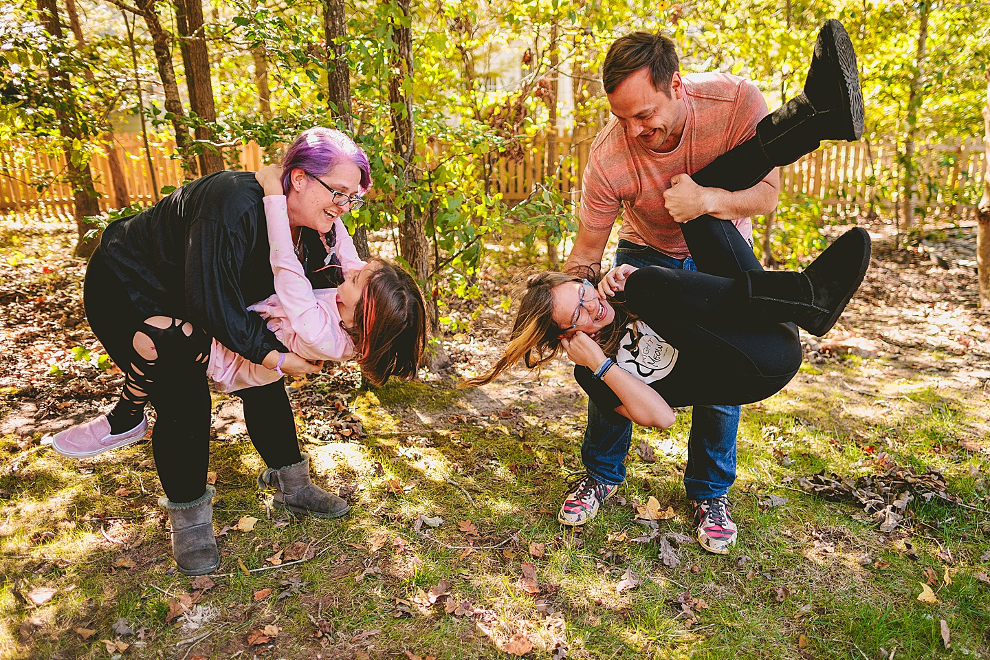 Picture of parents with their kids wrestling in the backyard in Holly Springs