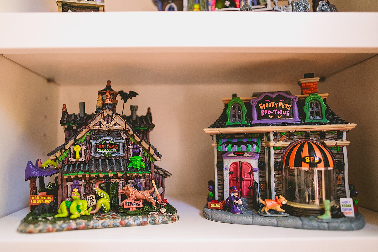 Pictures of Lemax Spookytown Halloween houses on a shelf