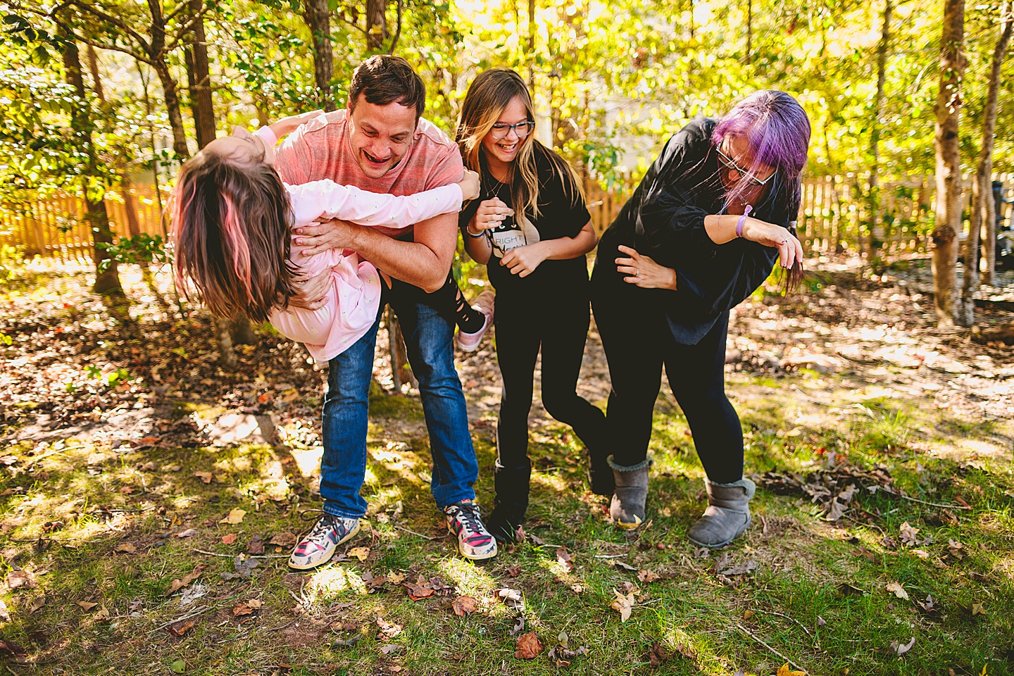 Picture of parents with their kids wrestling in the backyard in Holly Springs