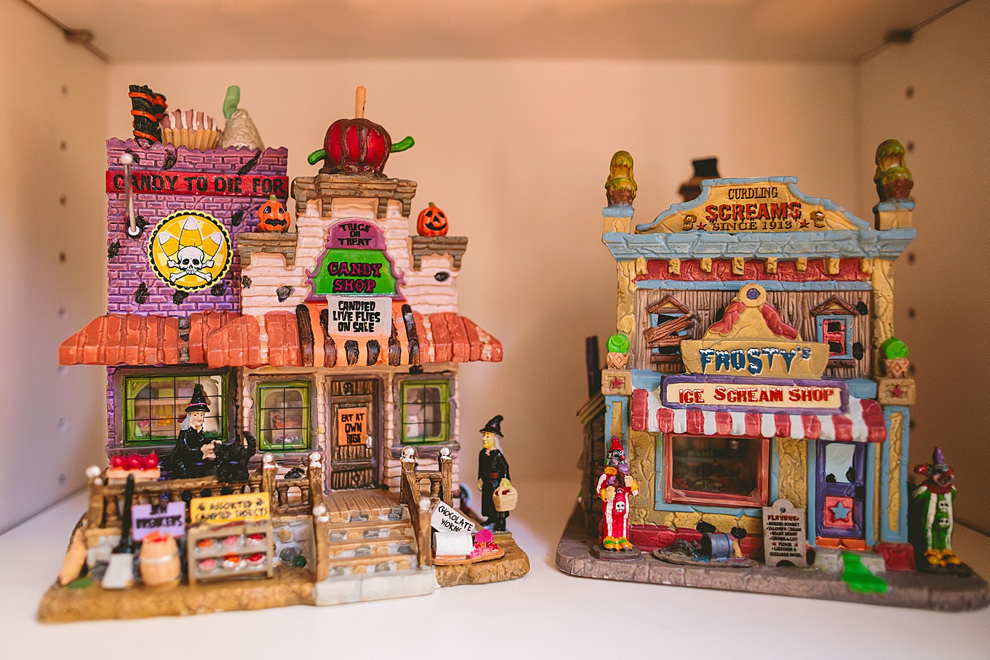 Pictures of Lemax Spookytown Halloween houses on a shelf