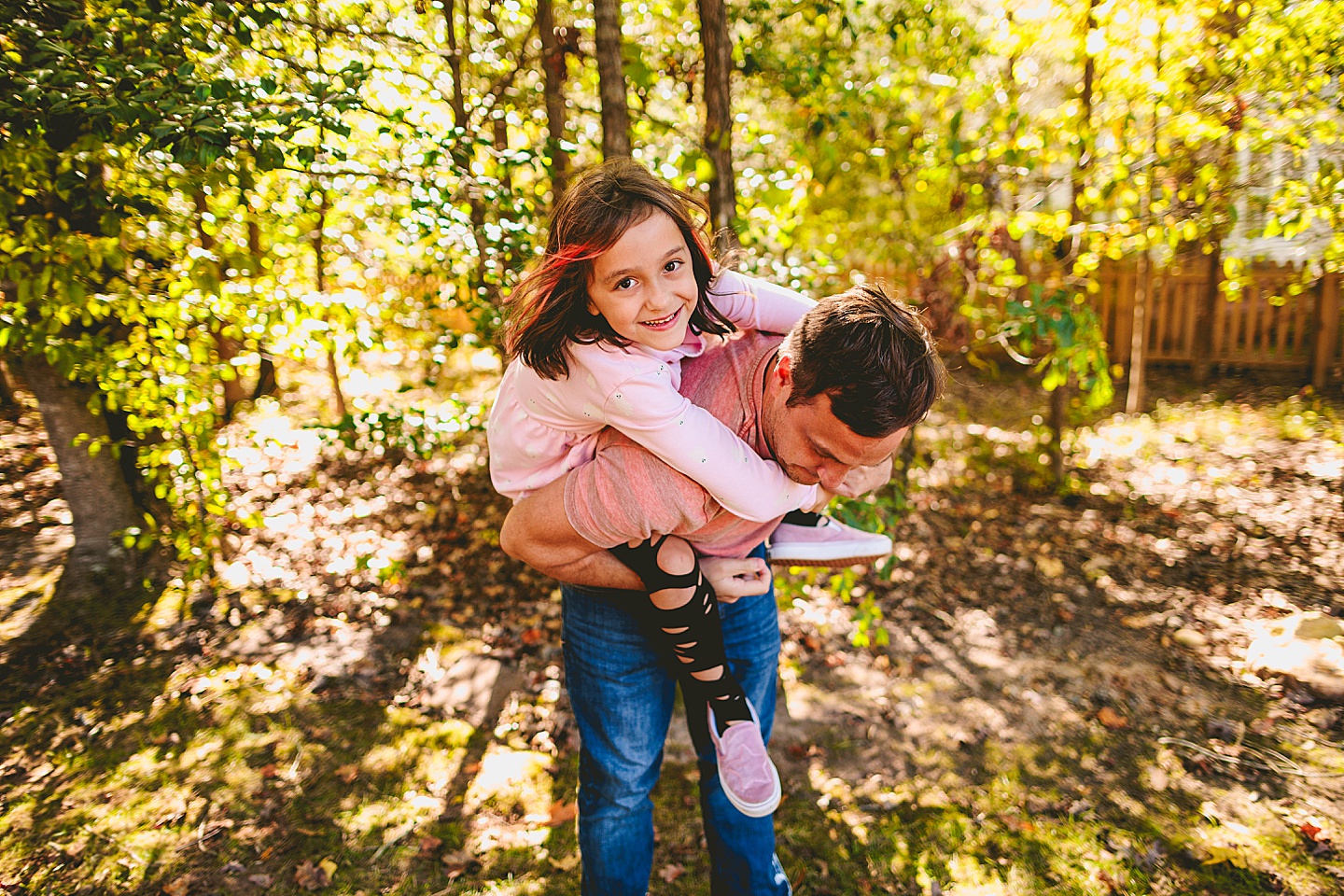 Father giving his daughter a piggyback ride