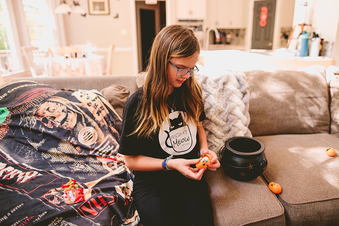 Girl opens up an orange Halloween egg with money inside