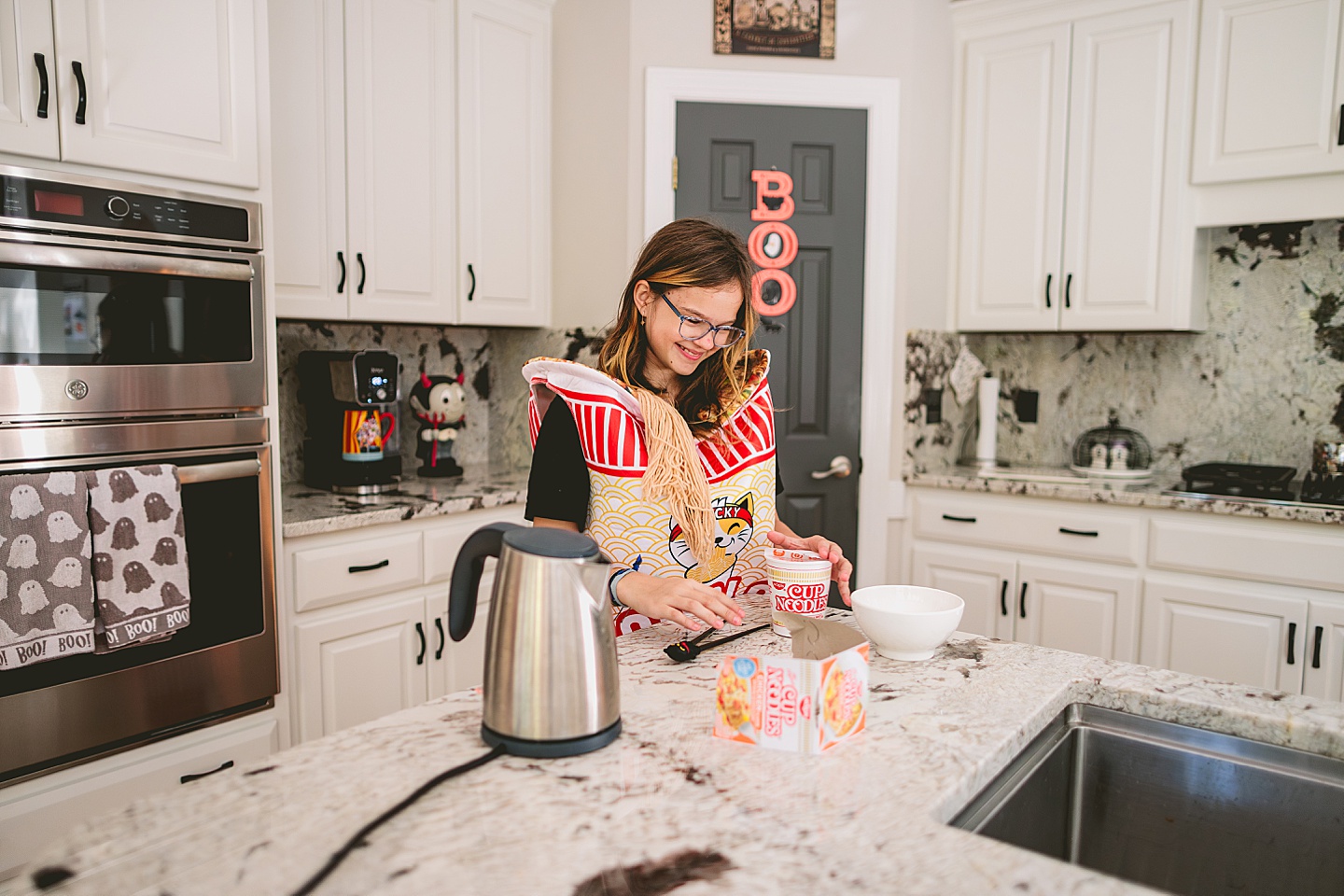 Girl prepares cup of noodle soup on kitchen counter
